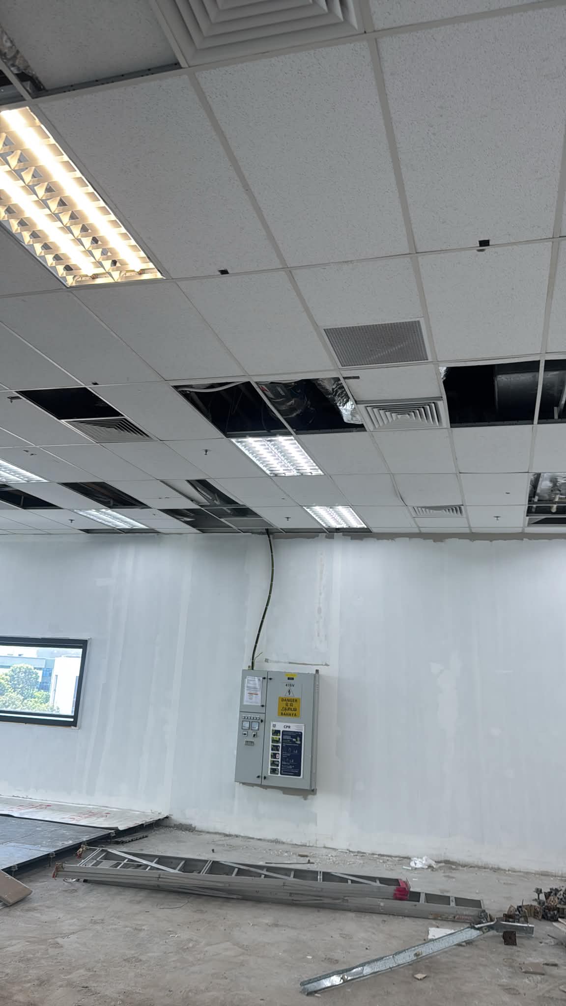 AR Ceiling Partition Singapore — ceiling tile and light fitting installation in an office | Ceiling Partition Singapore